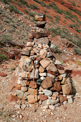 A large cairn marks where the trail arrives at the creek