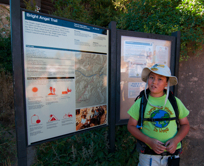 Matthew stands next to the sign at Bright Angel trailhead