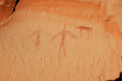 Pictograph showing two people and an animal