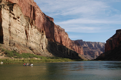 A lone raft floats down the Colorado River