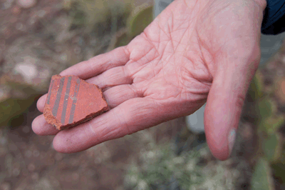 Rob holds a small potsherd in Kwagunt