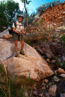 Rob stands atop a boulder next to the gushing spring source of Lava Creek