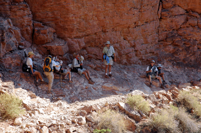 The guys share a shady spot with other hikers