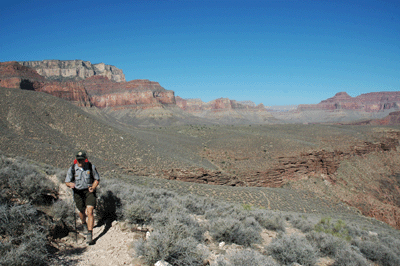 A Grand Canyon park ranger approaches along the Tonto Trail