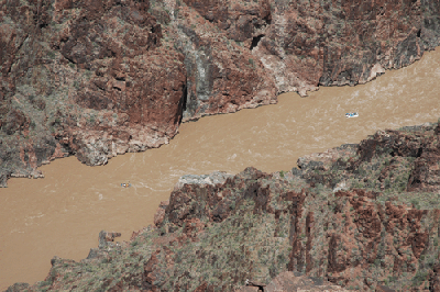 The white raft concludes its rumble through Sockdolager while the blue raft passes through the narrows