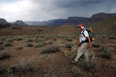 Dennis walking the Tonto with a thunderstorm dumping rain in the east