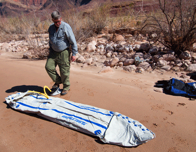 Dennis uses a foot pump to inflate the two-person Sea Eagle kayak