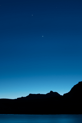 Venus and Jupiter stand over Vishnu Temple and the Colorado River at sunset