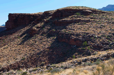 A group of hikers take shelter in shade along the Tonto trail