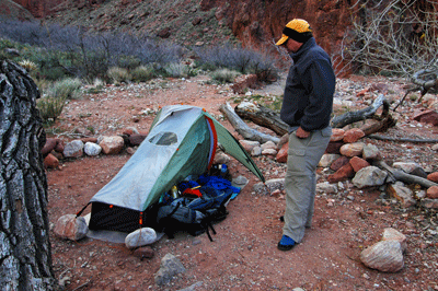 Dennis inspects his camp site at Clear Creek